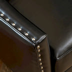 Poltrona Club in similpelle nera con borchie argentate e struttura in legno massello